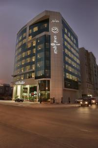 a building with a sign on the side of it at Safir Hotel Doha in Doha