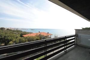 a balcony with a view of the ocean at Fattoria Nel Parco in Castiglioncello