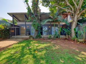 a house with a tree in front of it at Private Studio flatlet, Uncapped Wifi, Netflix,Full DSTV in Durban