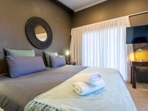 a bedroom with a large bed with towels on it at Private Studio flatlet, Uncapped Wifi, Netflix,Full DSTV in Durban