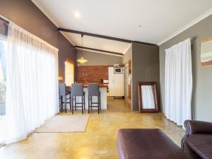 een woonkamer met een bank en een tafel bij Private Studio flatlet, Uncapped Wifi, Netflix,Full DSTV in Durban
