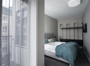 a bedroom with a bed and a large window at Reykjavik Residence Apartment Hotel in Reykjavík