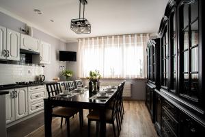 a dining room with a table and chairs in a kitchen at Willa Krakowska in Raszyn