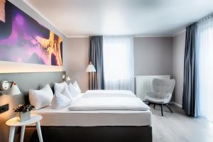 Postel nebo postele na pokoji v ubytování Offenbach Plaza Hotel