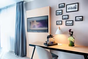TV a/nebo společenská místnost v ubytování Offenbach Plaza Hotel