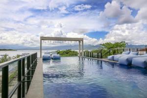 einen Resortpool mit Blick auf das Wasser in der Unterkunft Marc Hotel Gili Trawangan in Gili Trawangan