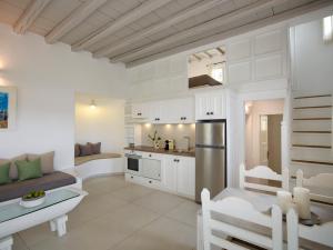 a white kitchen with a sink and a counter at Kallos of Mykonos in Ornos