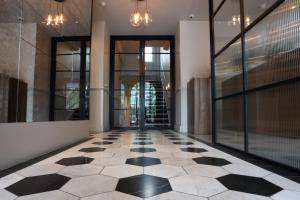 an empty hallway with a black and white checkered floor at Euston Square Hotel in London
