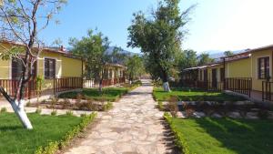 a cobblestone street in a village with houses at SELERDOĞA EVLERİ in Mugla