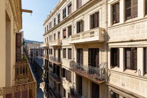 a row of buildings with balconies on a city street at Aspasios Gracia Apartments in Barcelona