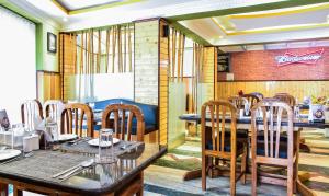 uma sala de jantar com mesas e cadeiras num restaurante em Itsy By Treebo - The Villa Retreat em Siliguri