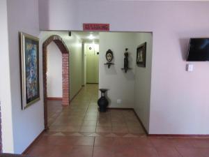 an empty hallway with a sign on the wall at faces guesthouse in Bethlehem