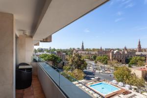 a large building with a balcony overlooking a city at Melia Sevilla in Seville