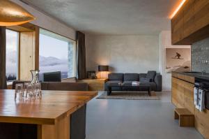 a living room with a couch and a table at rocksresort in Laax