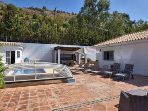 a patio with a swimming pool and a house at Homely holiday home in Benalm dena with private pool in Benalmádena