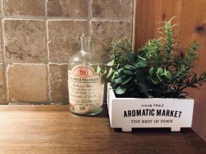 a bottle of alcohol next to a potted plant at Le Coin Savoyard in Combloux