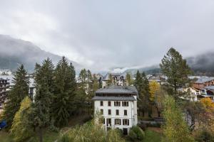 een groot wit huis bovenop een heuvel bij Apartment Chamois Blanc 6 in Chamonix-Mont-Blanc
