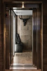 an open door with a bull head on a wall at Neko Boutique Hotel in Cagliari