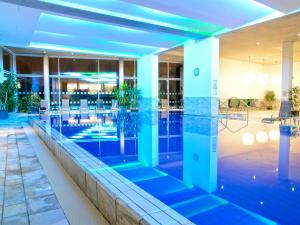 a large swimming pool in a hotel room at Hotel de France in Saint Helier Jersey