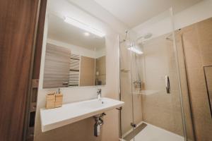 a bathroom with a sink and a shower at Beautiful new studio, 400m from the square in Plzeň