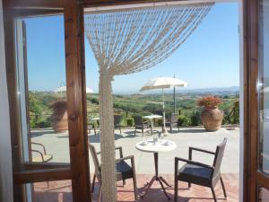 a patio with a table and chairs and an umbrella at B&B I Coppi in San Gimignano