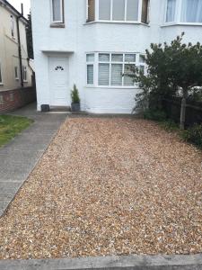 a house with a gravel driveway in front of it at Epicsa - 3 Bedroom Family & Corporate Stay, Garden and FREE parking in Cambridge
