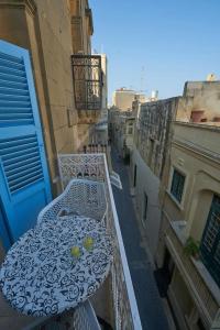 balcón con mesa y sillas en Magic in the Heart of Old Gozo (Penthouse), en Victoria