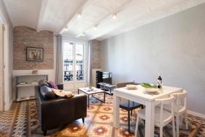 a living room with a couch and a table at Fuster Apartments by Aspasios in Barcelona