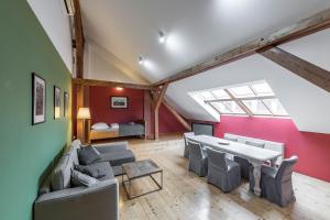 a living room with a table and chairs and a bedroom at Liliova Apartments in Prague