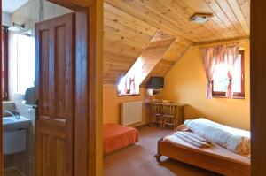 a bathroom with a bed and a sink in a room at PENZIONHARMONIA eu in Lendak