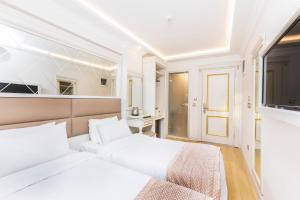 Postel nebo postele na pokoji v ubytování City Hall Hotel Sultanahmet