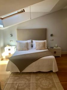 a bedroom with a large bed with pillows at Bournacell 16 in Cambados