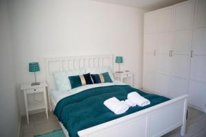 a bedroom with a bed with two towels on it at Antalóczy Winery&Apartments in Tokaj