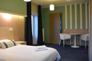 Postel nebo postele na pokoji v ubytování Alba Hotel