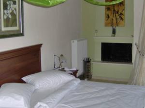 Ένα ή περισσότερα κρεβάτια σε δωμάτιο στο Ξενώνας Το Φράγμα