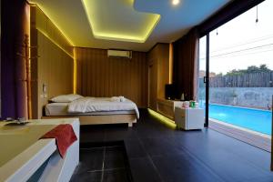 a bedroom with two beds and a swimming pool at ลอฟท์แอทสีมา สาขา2 in Nakhon Ratchasima