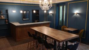 a dining room with a wooden table and chairs at Manoir le Roure in Châteauneuf-du-Rhône