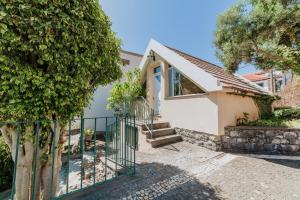 a house with a staircase and a fence at Villa Sol in Ponta do Sol