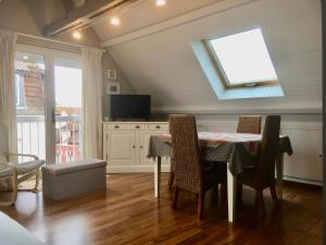 a dining room with a table and some chairs at Iroise Duplex T3 in Le Touquet-Paris-Plage