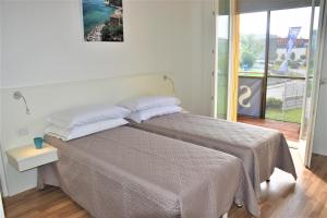 Posteľ alebo postele v izbe v ubytovaní ASPIO RESIDENCE