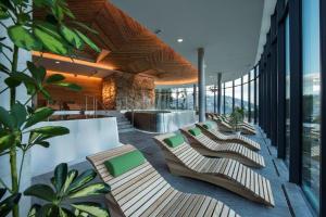 a row of chaise lounges on a building at Hotel SOREA SNP in Belá