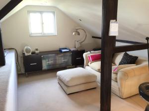 a living room with a couch and a table at Castle Mill Bed and Breakfast in Dorking