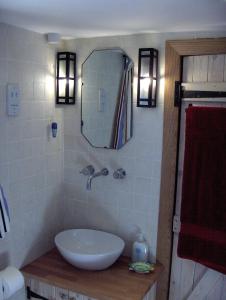 a bathroom with a sink and a mirror at Manor Holding Byre in Bewdley