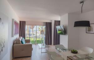a living room with a couch and a table at Flamingo Beach Mate in Adeje