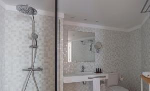a bathroom with a shower and a sink and a mirror at Flamingo Beach Mate in Adeje