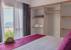 a bedroom with a bed and a large window at Flamingo Beach Mate in Adeje