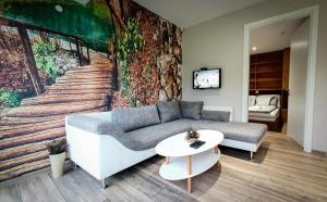 a living room with a couch and a table at Bungalovi Ključ in Ključ
