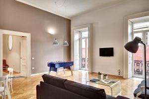 a living room with a couch and a blue table in it at Hotel Piazza Bellini & Apartments in Naples