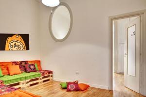 a living room with a green couch and a mirror at Hotel Piazza Bellini & Apartments in Naples