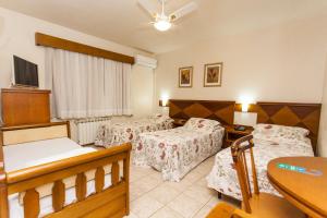 Ένα ή περισσότερα κρεβάτια σε δωμάτιο στο Tri Hotel Lago Gramado